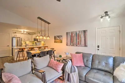 a living room with a couch and a kitchen at Balcony and Hot Tub Access Modern Breck Escape! in Breckenridge