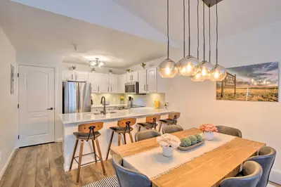 a kitchen and dining room with a table and chairs at Balcony and Hot Tub Access Modern Breck Escape! in Breckenridge