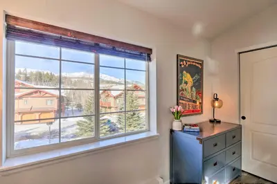 a bedroom with a window with a mountain view at Balcony and Hot Tub Access Modern Breck Escape! in Breckenridge