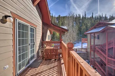 a wooden deck with a table and chairs on a house at Balcony and Hot Tub Access Modern Breck Escape! in Breckenridge