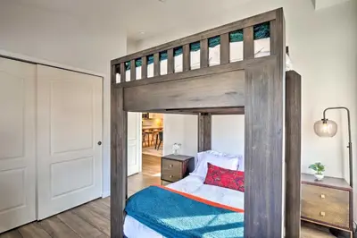 a bedroom with a large wooden bunk bed with blue sheets at Balcony and Hot Tub Access Modern Breck Escape! in Breckenridge