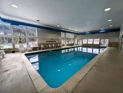 a large swimming pool with blue water in a house at Lenawee 1741 by SummitCove Lodging in Keystone