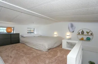 a white bedroom with a bed and a mirror at Sun & Snow Chalet Breckenridge, a dog lovers dream! in Breckenridge