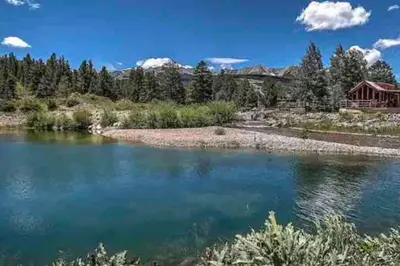 a view of a river with a house in the background at Sun & Snow Chalet Breckenridge, a dog lovers dream! in Breckenridge