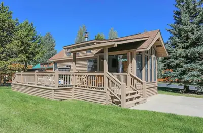 a house with a large deck on a lawn at Sun & Snow Chalet Breckenridge, a dog lovers dream! in Breckenridge