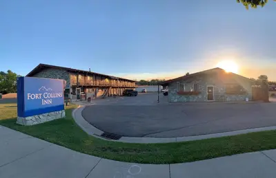 a building with a sign in front of it at Fort Collins Inn in Fort Collins