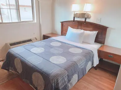 a hotel room with a bed and a window at Fort Collins Inn in Fort Collins