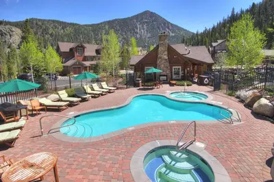 a large swimming pool with chairs and a house at Settlers Creek in Keystone