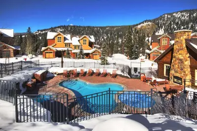a backyard with a swimming pool in the snow at Settlers Creek in Keystone