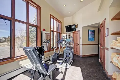 a fitness room with treadmills and exercise bikes at Red Hawk Lodge Condo in Keystone