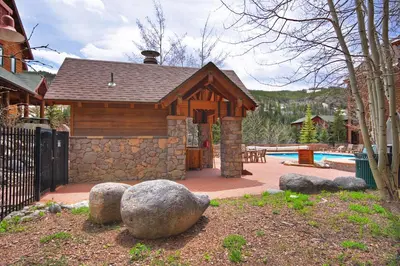 a small cabin with a pool in a yard at Dakota Lodge in Keystone