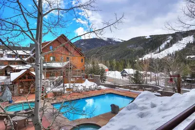 a swimming pool in the snow next to a building at Dakota Lodge in Keystone