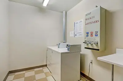 a bathroom with a washer and dryer in a room at Dakota Lodge in Keystone