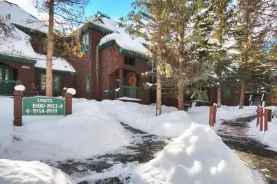 a sign in the snow in front of a house at Soda Springs Condominiums in Keystone