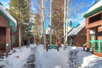 a street covered in snow next to a building at Soda Springs Condominiums in Keystone