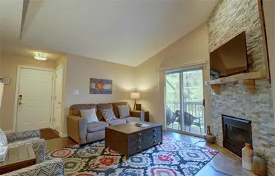 a living room with a couch and a fireplace at 201 Point Drive condo in Frisco