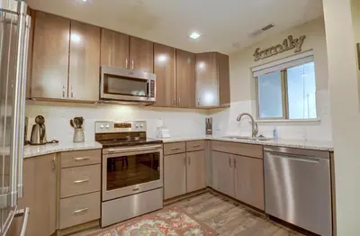 a kitchen with wooden cabinets and stainless steel appliances at 201 Point Drive condo in Frisco
