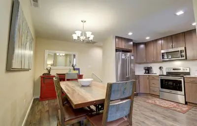 a kitchen with a wooden table and a dining room at 201 Point Drive condo in Frisco