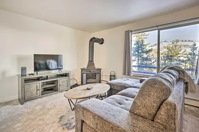a living room with a couch and a fireplace at Steps to Dillon Reservoir Mtn-View Condo in Dillon