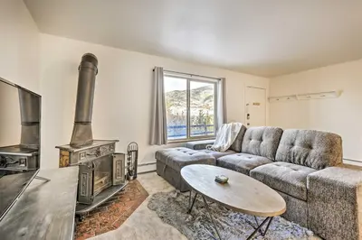 a living room with a couch and a stove at Steps to Dillon Reservoir Mtn-View Condo in Dillon