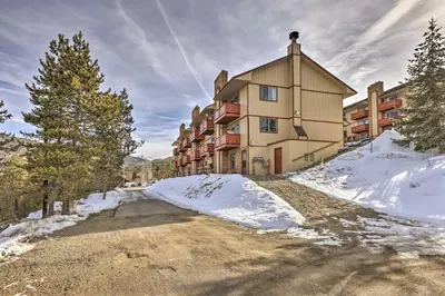 a building on a snow covered road in front at Steps to Dillon Reservoir Mtn-View Condo in Dillon