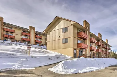 an apartment building with snow in front of it at Steps to Dillon Reservoir Mtn-View Condo in Dillon