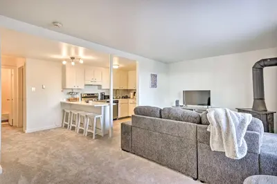 a living room with a couch and a kitchen at Steps to Dillon Reservoir Mtn-View Condo in Dillon
