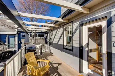 a deck with two chairs on a house at Brilliant Posh Home - Backs to Poudre River Trail! in Fort Collins