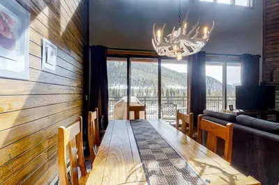 a dining room with a table and a chandelier at Montezuma Magic in Keystone