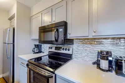 a kitchen with a stove and a microwave at Montezuma Magic in Keystone