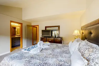 a bedroom with a large bed and a television at Montezuma Magic in Keystone
