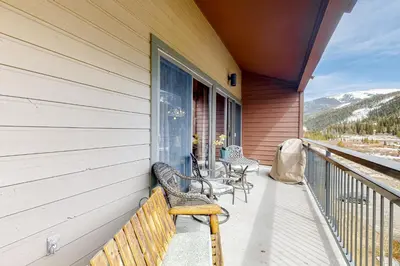 a porch of a house with chairs and a table at Montezuma Magic in Keystone