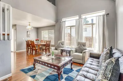 a living room with a couch and a table at 15 Mi to Downtown Denver Home with Yard and Patio in Aurora