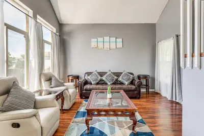 a living room with couches and a coffee table at 15 Mi to Downtown Denver Home with Yard and Patio in Aurora