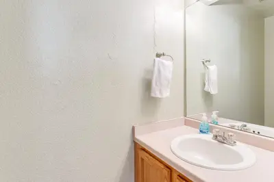 a bathroom with a sink and a mirror at 15 Mi to Downtown Denver Home with Yard and Patio in Aurora