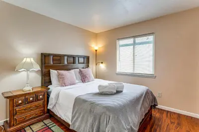 a bedroom with a large bed and a window at 15 Mi to Downtown Denver Home with Yard and Patio in Aurora