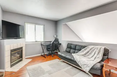 a living room with a couch and a television at 15 Mi to Downtown Denver Home with Yard and Patio in Aurora