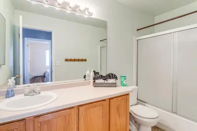 a bathroom with a sink and a toilet and a mirror at 15 Mi to Downtown Denver Home with Yard and Patio in Aurora