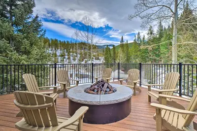 a patio with chairs and a fire pit on a deck at Chic Winter Park Studio with Community Hot Tub in Winter Park