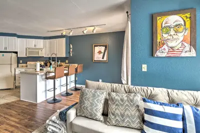 a living room with a couch and a kitchen at Chic Winter Park Studio with Community Hot Tub in Winter Park