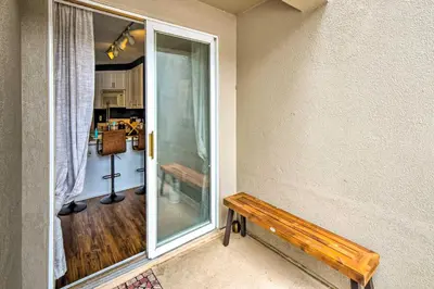 a room with a window and a wooden bench at Chic Winter Park Studio with Community Hot Tub in Winter Park