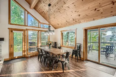 a dining room with a wooden table and chairs at Moose Ridge Cabin cabin in Grand Lake