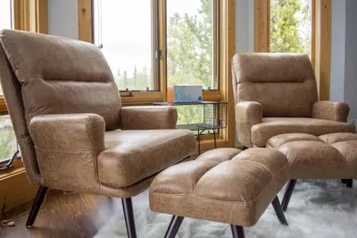 two chairs and a ottoman in a living room at Moose Ridge Cabin cabin in Grand Lake
