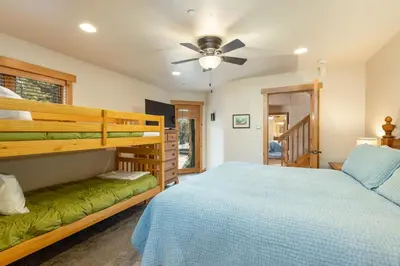 a bedroom with a bunk bed and a ceiling fan at 8201 Mill Creek - Private Hot Tub! condo in Dillon