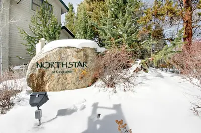 a sign on a rock in the snow at Northstar 1962 by SummitCove Lodging in Keystone