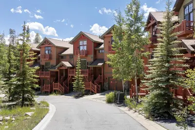 a row of apartment buildings on a road at Bear Trail townhouse in Winter Park
