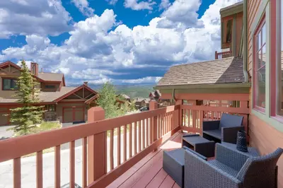 a balcony with chairs on a house at Bear Trail townhouse in Winter Park