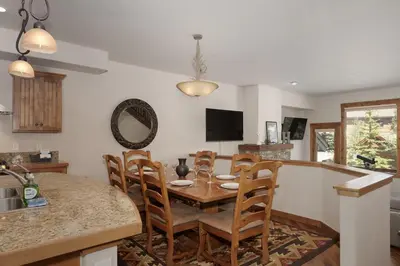 a kitchen and dining room with a table and chairs at Bear Trail townhouse in Winter Park