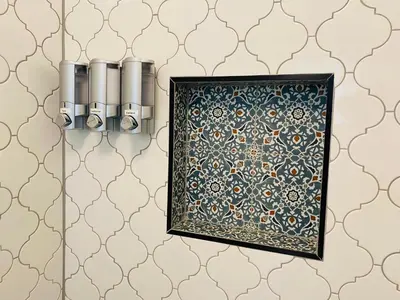 a bathroom with a wall of wallpaper with a picture frame at Flora House Denver in Denver