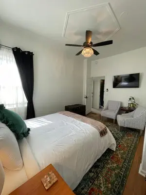 a bedroom with a bed and a ceiling fan at Flora House Denver in Denver